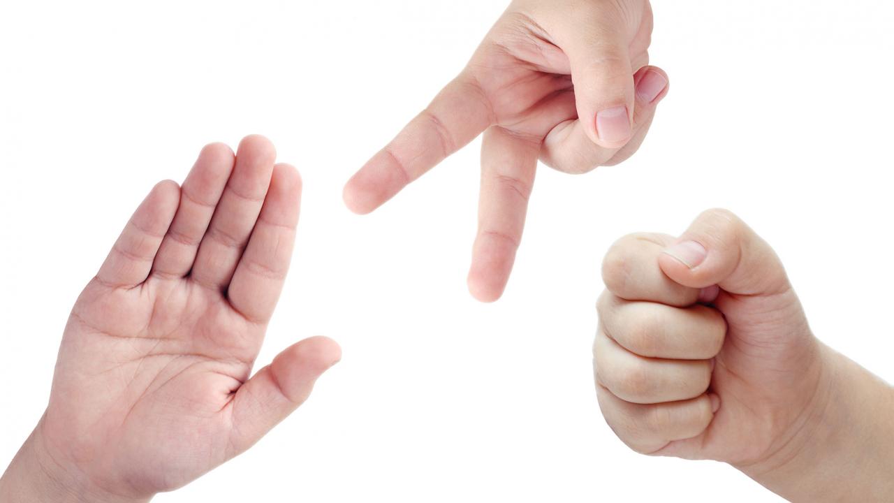 hands playing rock, paper, or scissors